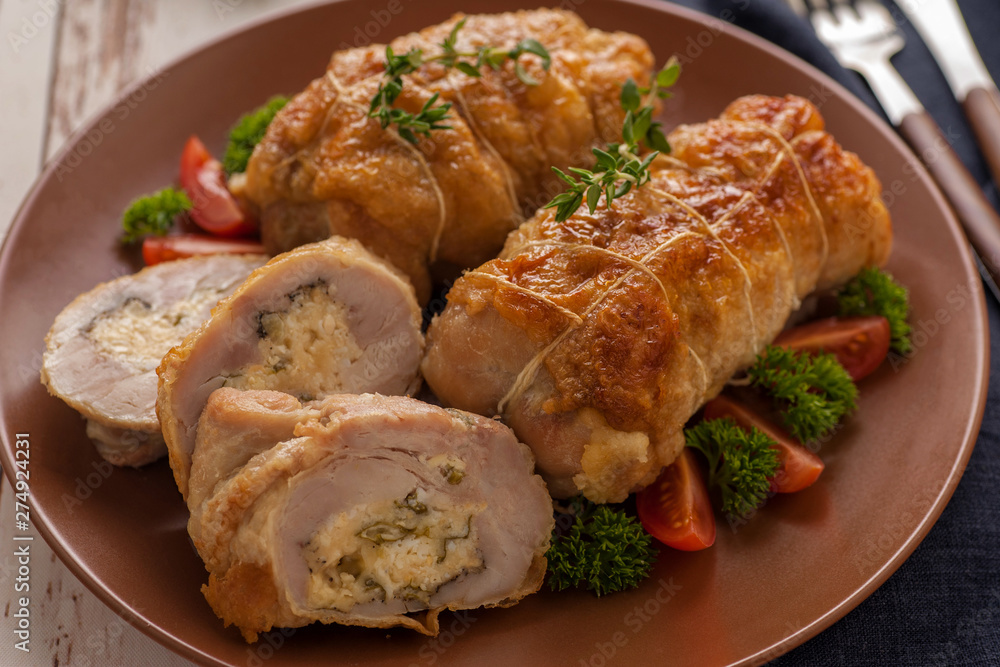 Stuffed chicken roll s vegetable garnish and herbs. Stuffed chicken roll s vegetable garnish and herbs.