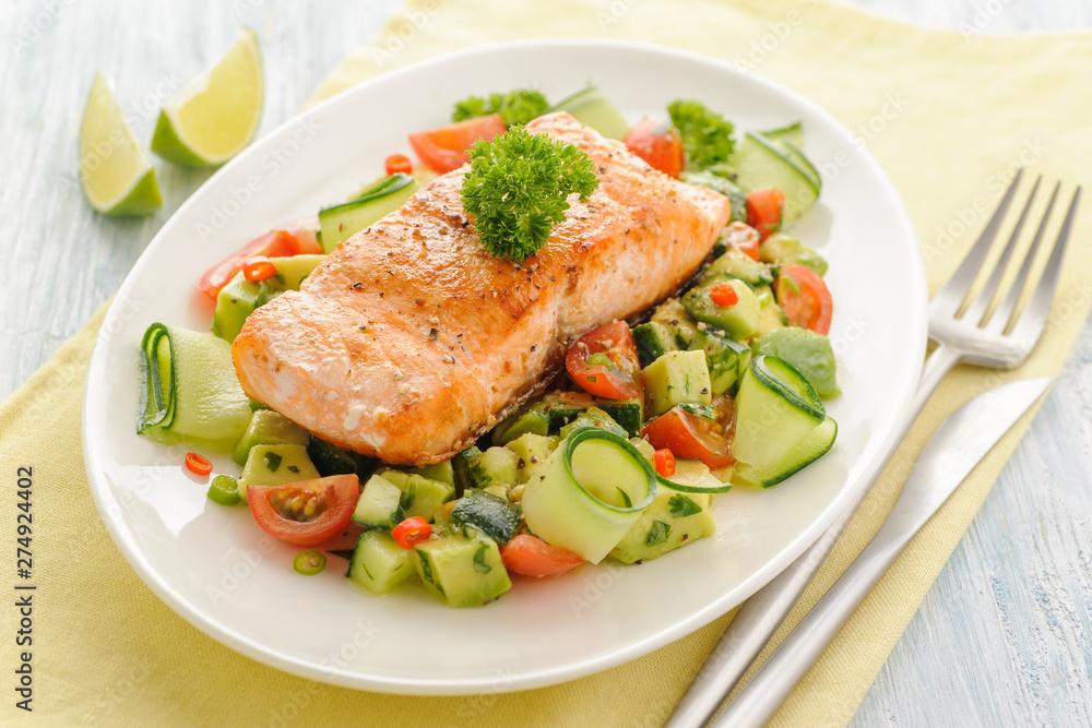 Grilled salmon fillet with vegetable salad.