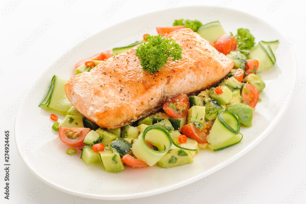 Grilled salmon fillet with vegetable salad. Grilled salmon fillet with vegetable salad.