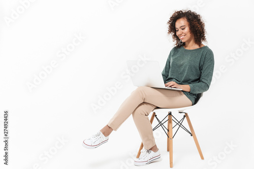 Fotografie, Obraz Attractive young african woman sitting on a chair