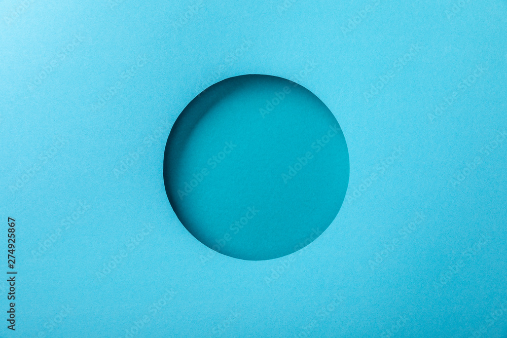 blue paper background with minimalistic round hole blue paper background with minimalistic round hole