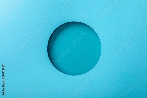 blue paper background with minimalistic round hole photo