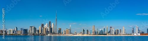 Canvas Wide panorama of Dubai cityscapes with Burj Khalifa at daytime