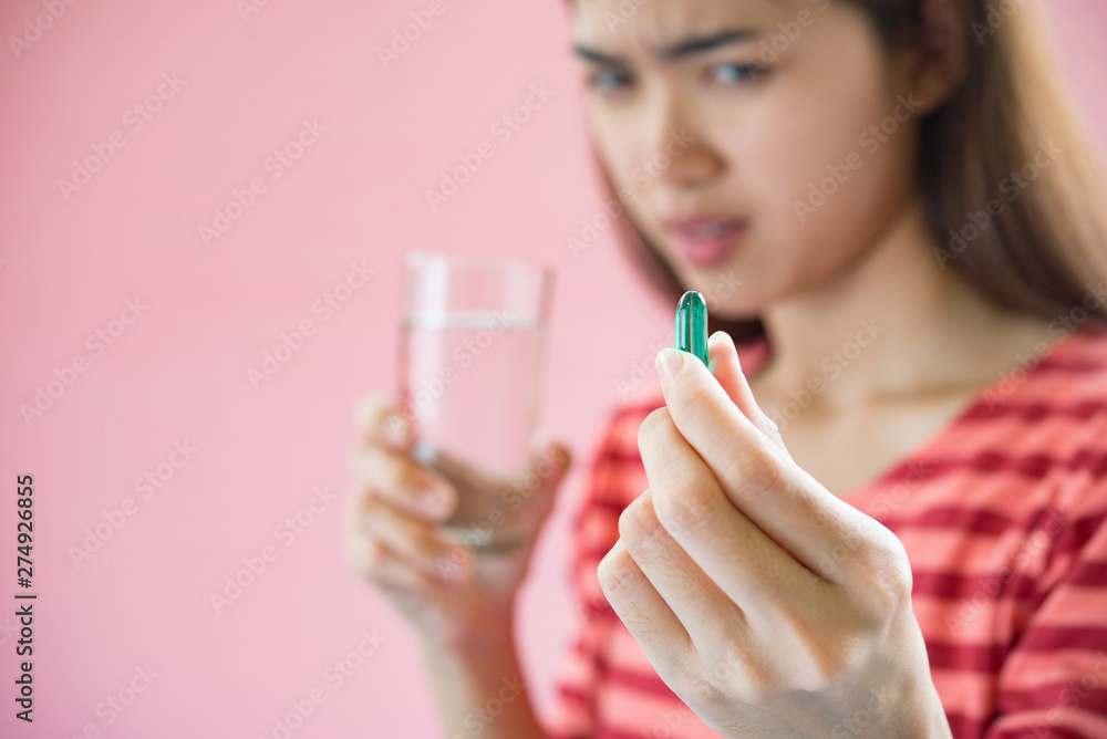 Young woman taking medicine pill after doctor order Young woman taking medicine pill after doctor order