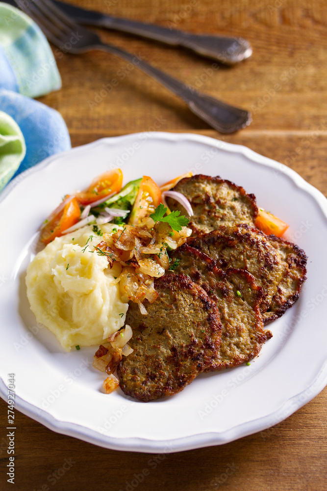 Beef liver pancakes with mashed potato and vegetables. Liver side dish