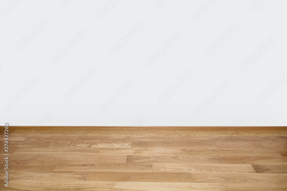 Copyspace background with an empty white wall with a hardwood wooden floor below and copy space for your text or advertisement Copyspace background with an empty white wall with a hardwood wooden floor below and copy space for your text or advertisement