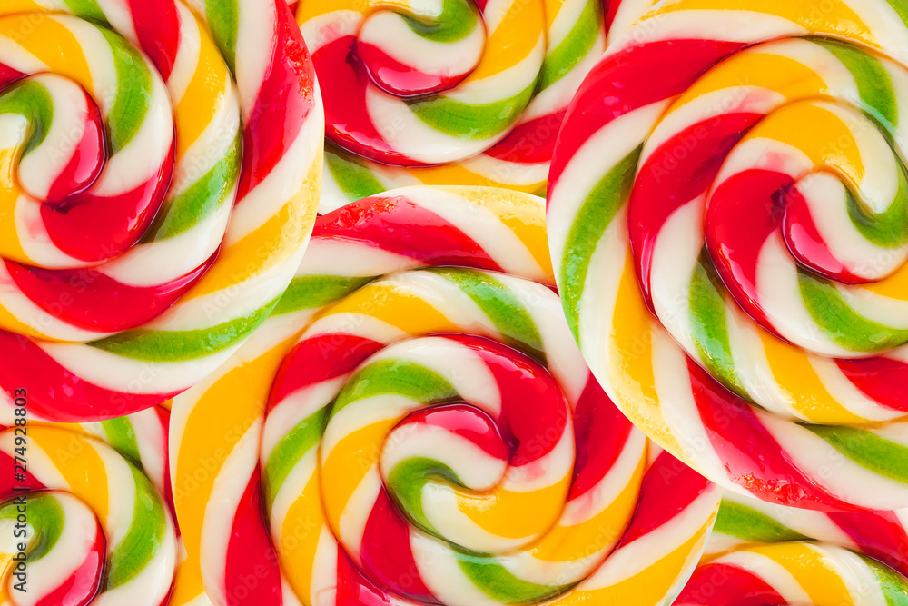 Abstract background texture of round lollipops. Rainbow colorful background of sweets and candies