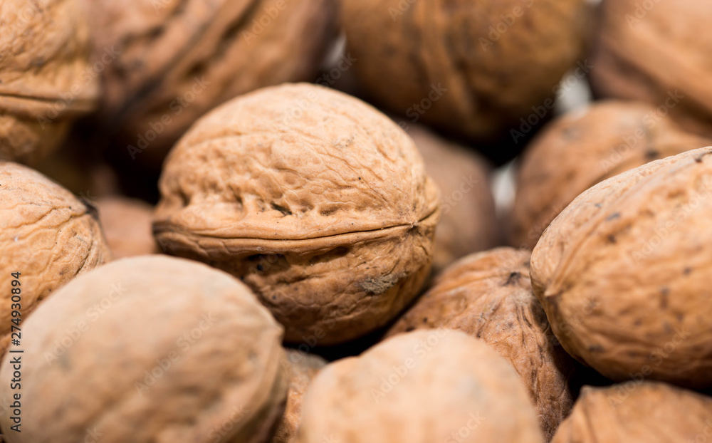 A bunch of dried walnuts close up macro shot, image for background. A bunch of dried walnuts close up macro shot, image for background.