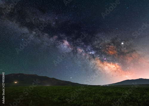 The green field and milky way galaxy. Beautiful starry night.  Space background.