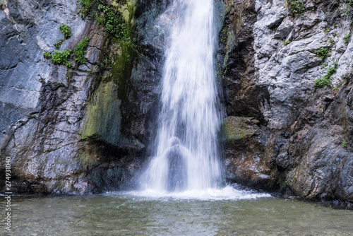 Silhouette of person cooling off under Eaton Falls in the San Gabriel Mountains near Pasadena in Southern California. 