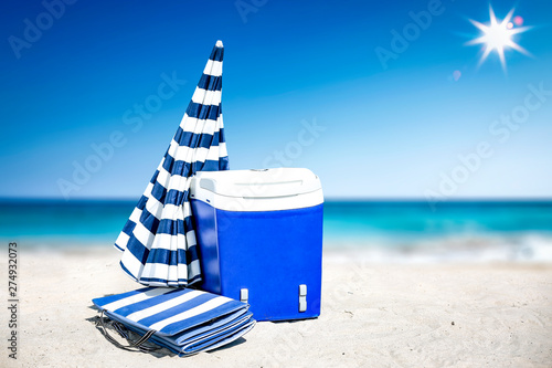 Summer time on beach and free space for your decoration. Blue and white umbrella with landscape of ocean. 