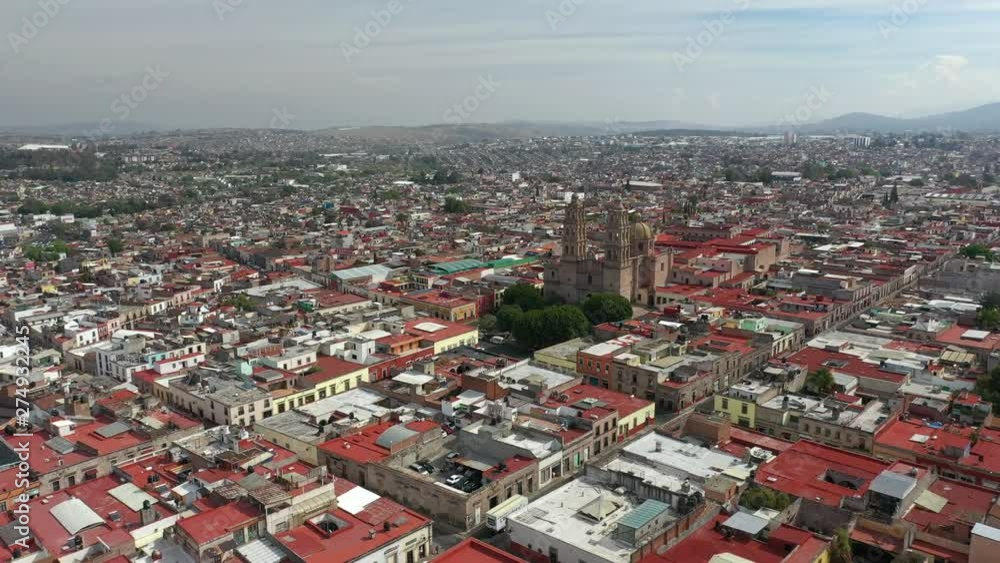 Aerial Drone View over the colorful rooftops and a church in Morelia, Michoacan, Mexico Aerial Drone View over the colorful rooftops and a church in Morelia, Michoacan, Mexico