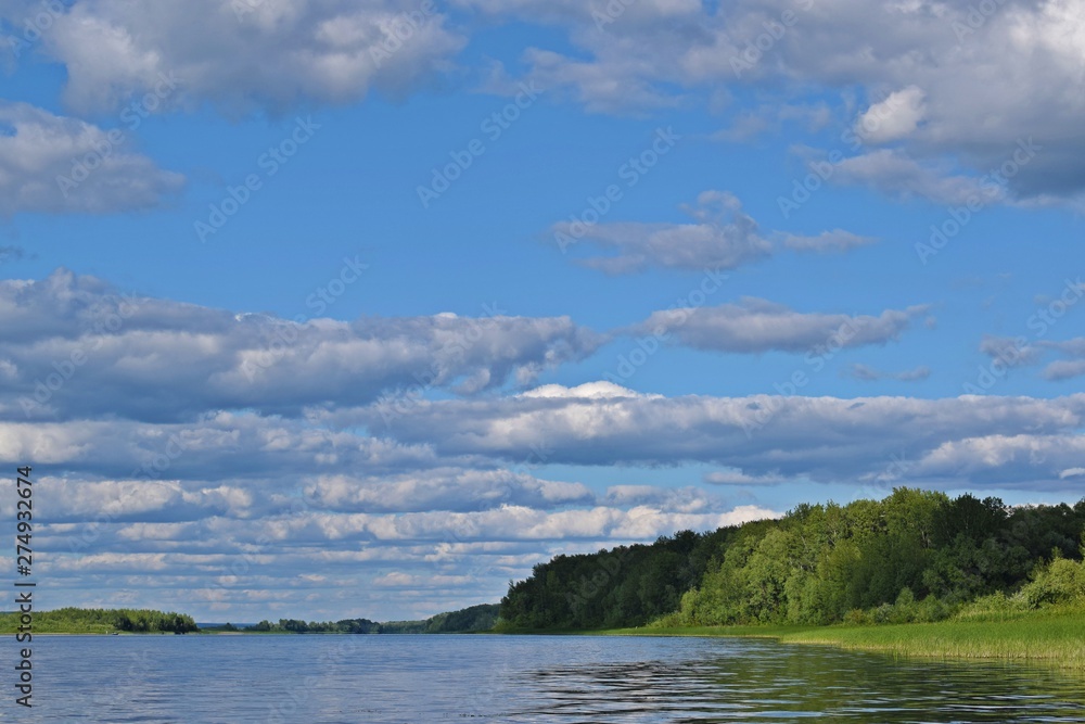 Picturesque summer landscape.Reflection of clouds in the river.