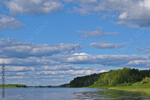 Picturesque summer landscape.Reflection of clouds in the river. © NADEZHDA