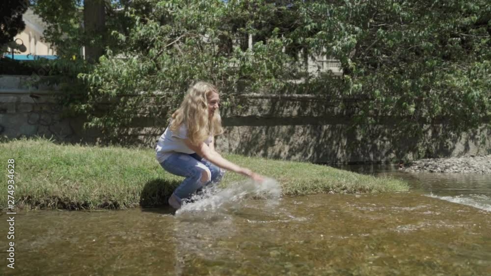 Girl splashing water from the river 4k slow motion Girl splashing water from the river 4k slow motion
