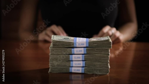 Wallpaper Mural Sexy woman pushes a stack of money accross a table. Torontodigital.ca