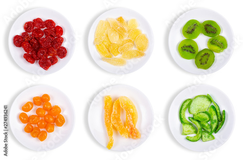 Set plates candied dried tropical fruits on the white background isolation, top view