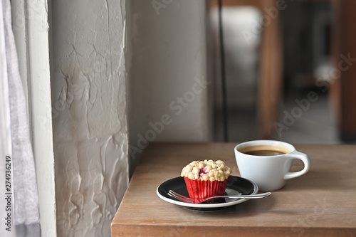 Fototapeta Naklejka Na Ścianę i Meble -  Breakfast with black coffee and muffin homemade on wood table.