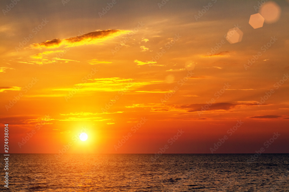 beautiful bright sunset over the sea with clouds in the sky
