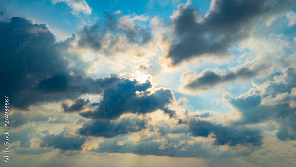 The sun light passes through the clouds at sunset. The sun light passes through the clouds at sunset.