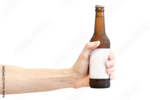 Brown glass beer bottle with white blank label in men’s hand isolated on a white background. 300 ml bottle with condensate. Holds straight photo