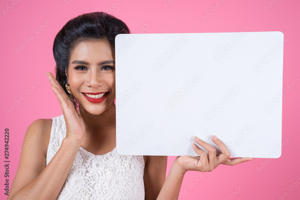 Portrait of fashion woman displaying white banner Portrait of fashion woman displaying white banner