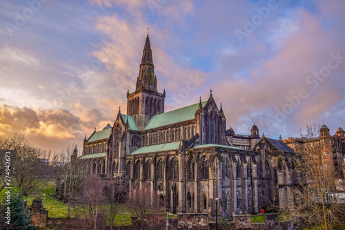 Beautiful Glasgow St Mungo’s Cathedral illuminated clouds in sunset	 photo