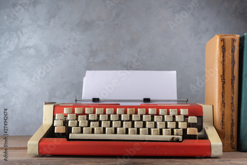 Old red typewriter and books