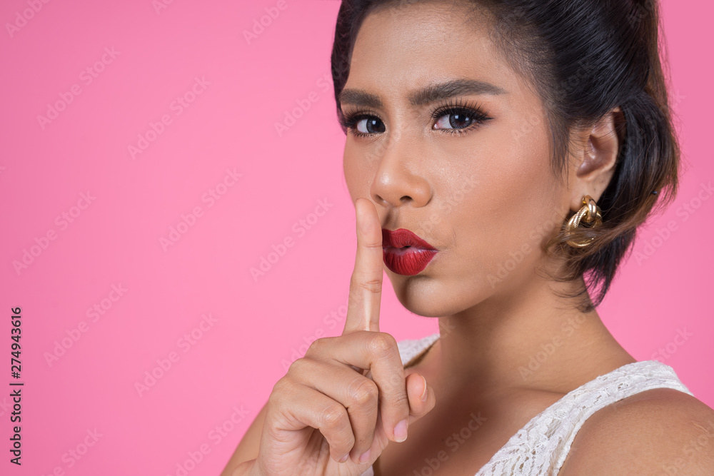 Beauty asian woman red lips and finger showing hush silence sign Beauty asian woman red lips and finger showing hush silence sign