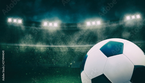 Close up of a soccer ball at the stadium during a night match