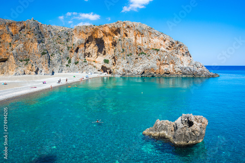 Fototapeta Naklejka Na Ścianę i Meble -  Agiofarago beach with natural caves and stone arches at the end of the gorge in Crete island, Greece