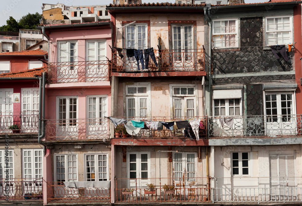 Balconies of historical houses, with drying wear, small flats and rustic walls.