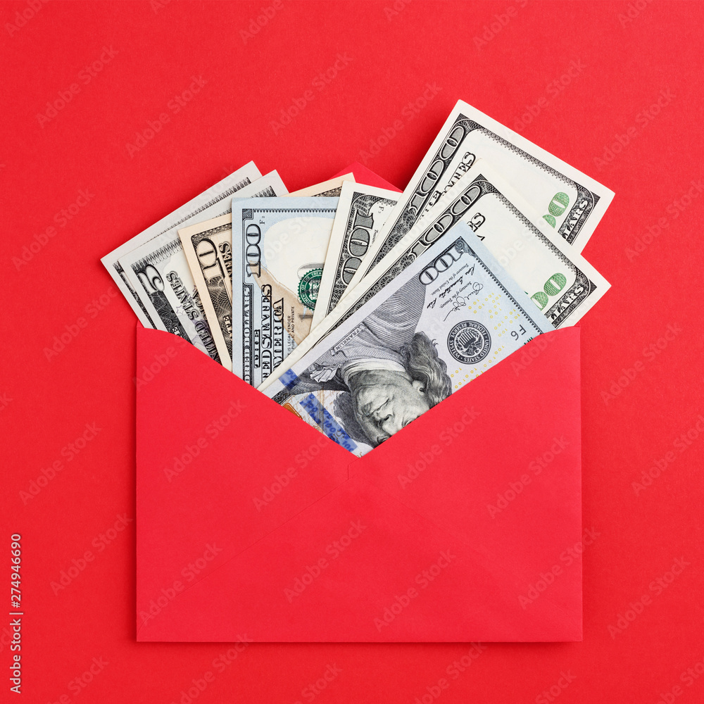 Fan US dollars in cash in red envelope on red background. Money