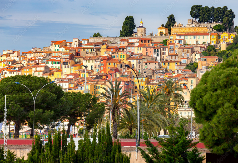 Obraz premium Menton. Antique multi-colored facades of medieval houses on the shore of the bay.