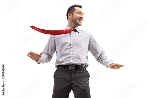 Fotografi Cheerful young businessman ith his tie blown by wind