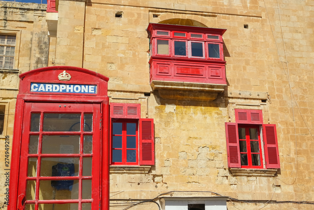 Vintage British Red telephone box in the old town, Valletta, Malta