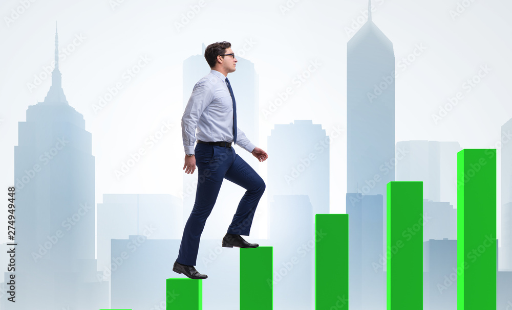 Businessman going up the bar chart in growth concept Businessman going up the bar chart in growth concept