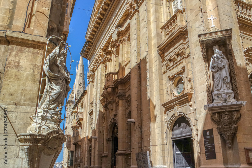 Sculptures are erected on the corner of a street in Valletta, Malta