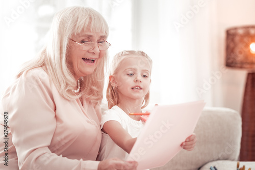 Fotografie Elegant grandmother spending wonderful time with her granddaughter