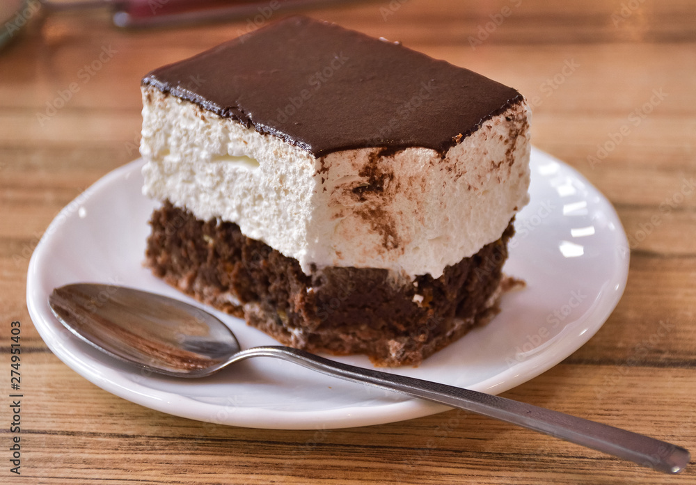 bitten cake on a plate with a spoon, cake Volga bitten cake on a plate with a spoon, cake Volga