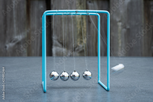 Photo Newtons cradle, physics experiment: collision balls in action