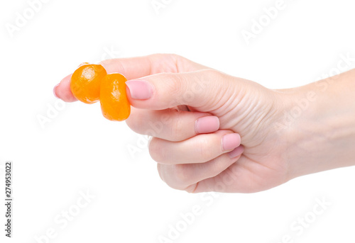 Candied dried kumquat in hand on white background isoltion