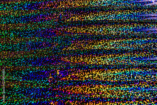 Photo of holographic real texture in rainbow colors, colorful iridescent surface. Holographic color wrinkled foil. Colored glitter. Shining background.