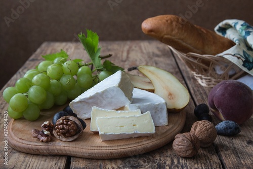 Still life with Brie cheese and green grapes photo