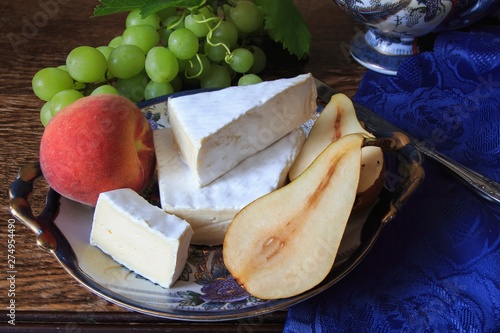 Still life with Brie cheese and green grapes photo