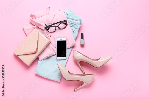 Stylish women's clothes with accessories on pink background