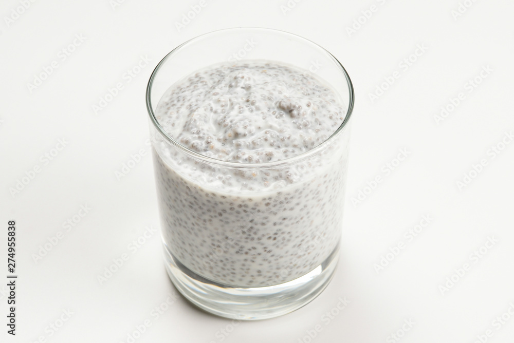 Chia pudding in glass on a white background. Space for text or design. Chia pudding in glass on a white background. Space for text or design.