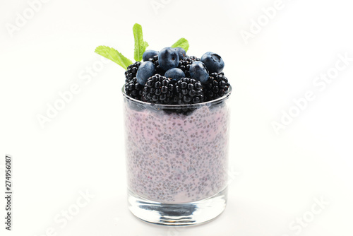 Chia pudding with mint, blueberry, blackberry on a white background. Space for text or design.