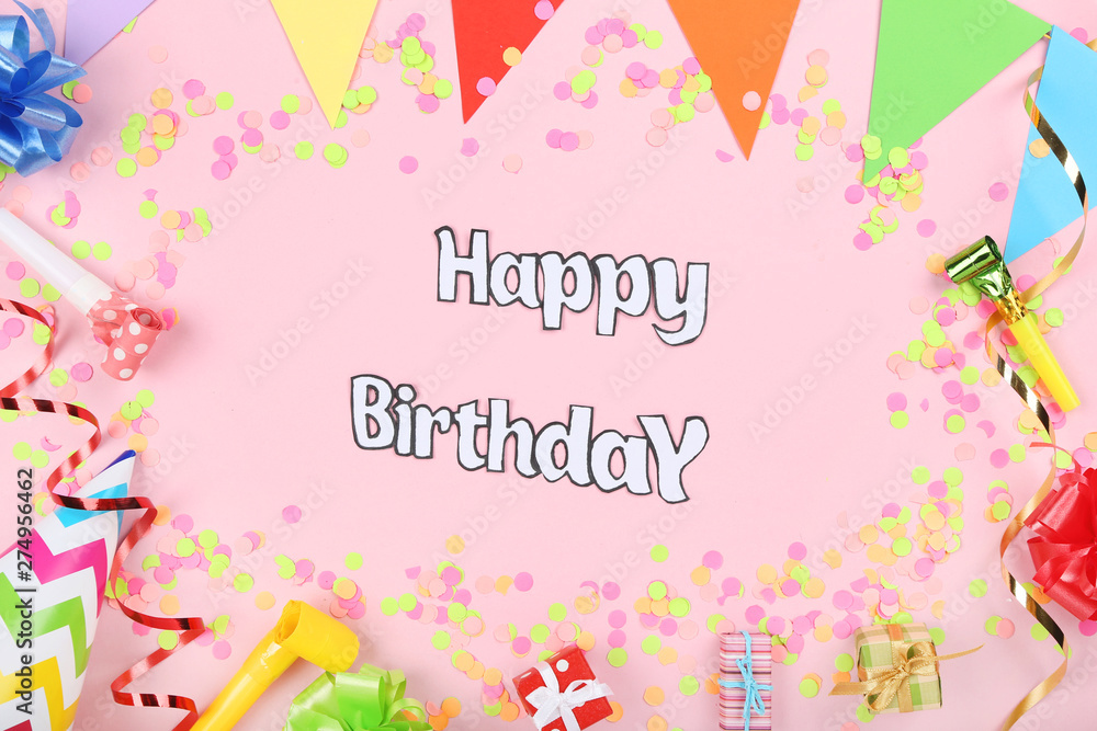 Text Happy Birthday with party decorations on pink background