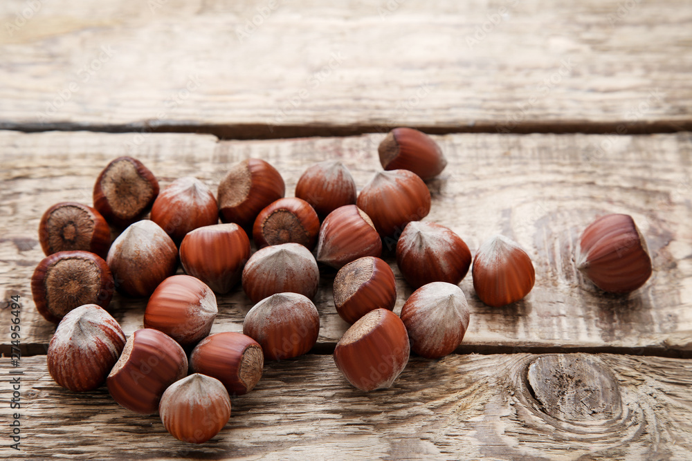 Ripe hazelnuts on brown wooden table Ripe hazelnuts on brown wooden table